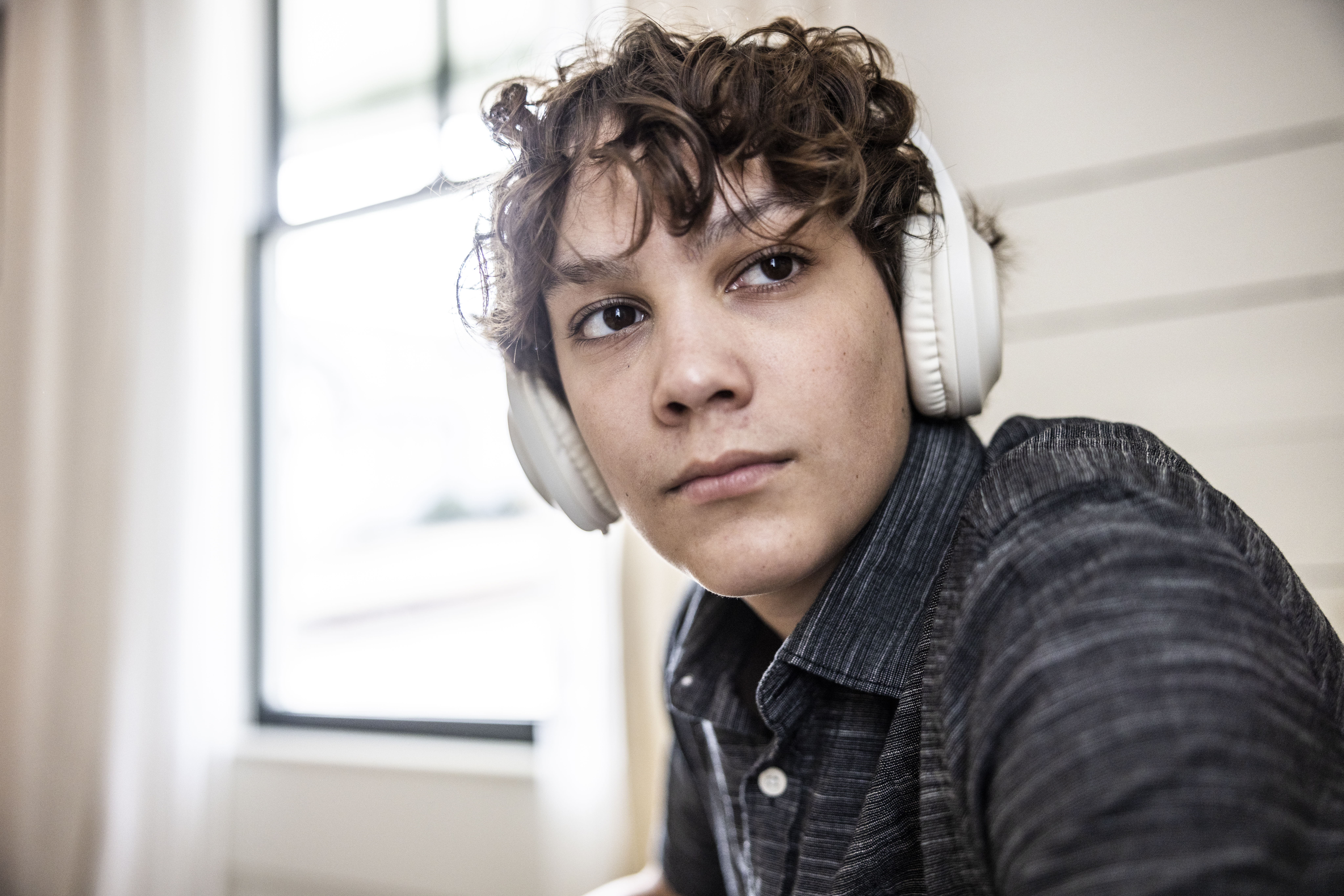 Teenage boy listening to wireless headphones